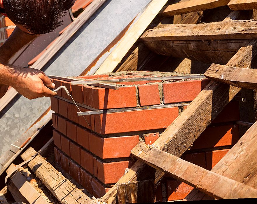 New brick courses running up an Arlington chimney rebuild