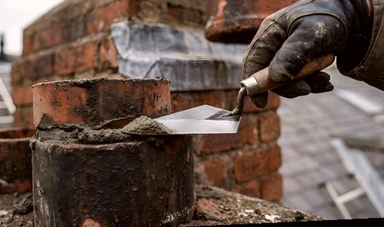 Refreshing joints around a chimney pot on an Arlington roof